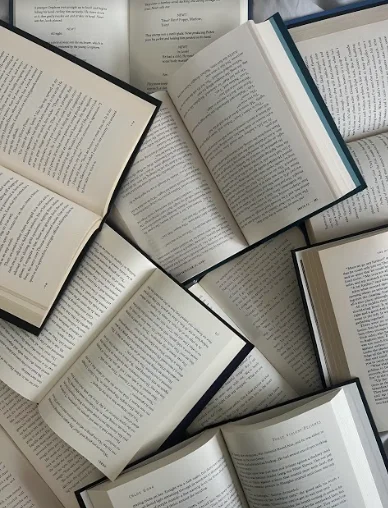 Open books scattered on a surface