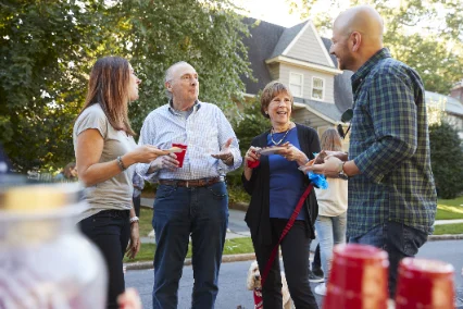 Neighbors greeting one another outside